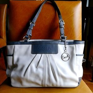 Elegant white and black Coach shoulder bag with purple lining